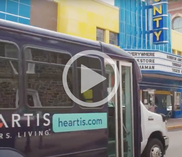 Heartis mini bus parked outside a movie theater